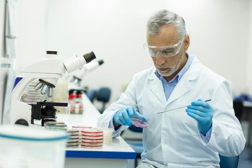 Attentive mature medical worker testing new equipment