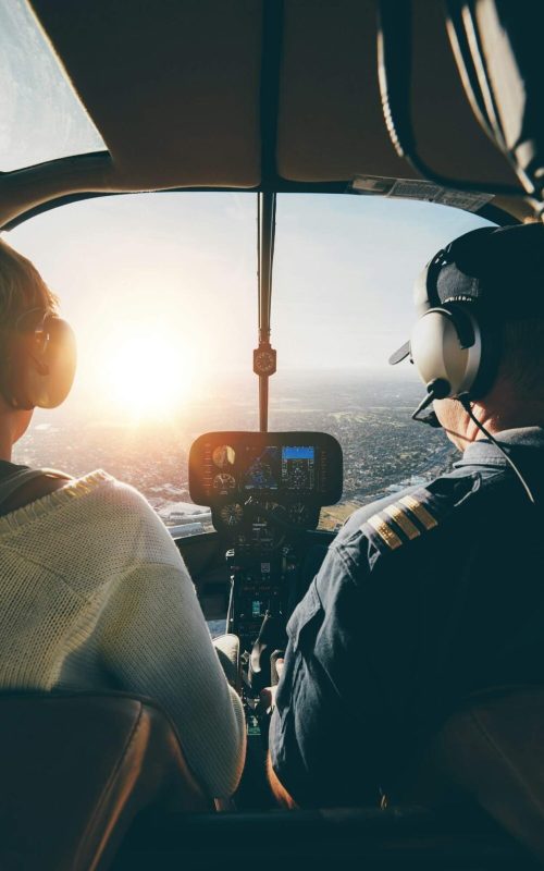 Pilots flying a helicopter on sunny day