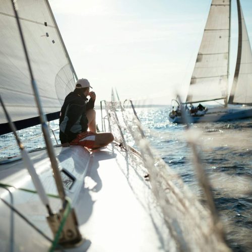 Young handsome man relaxing on his sailboat